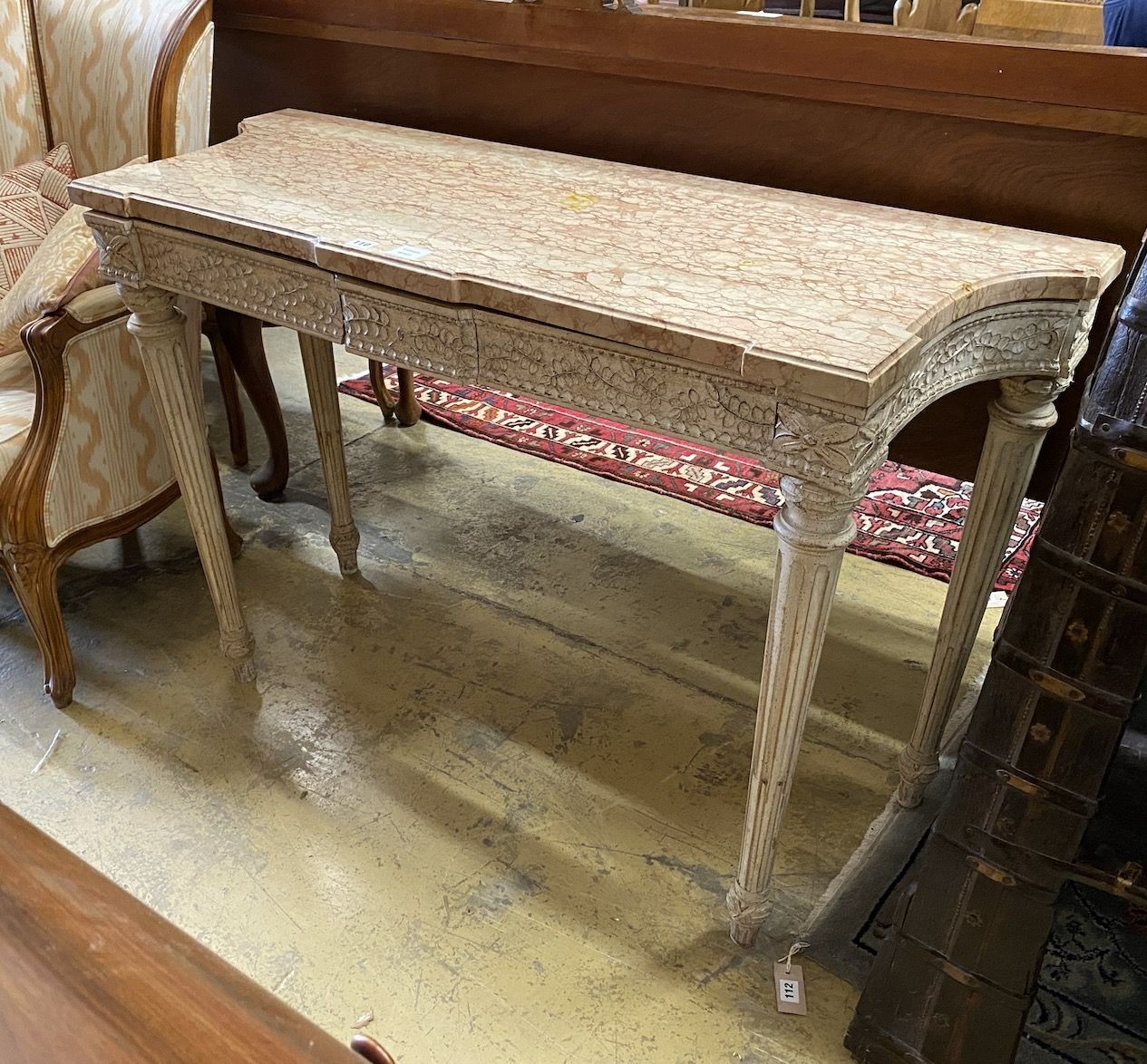 A Louis XVI style white painted carved wood marble topped two drawer console table, width 110cm, depth 47cm, height 82cm